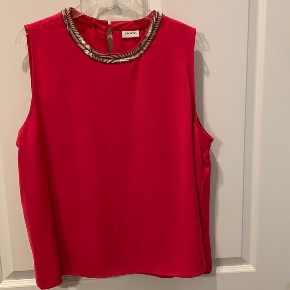 Sleeveless top with silver embellishments.